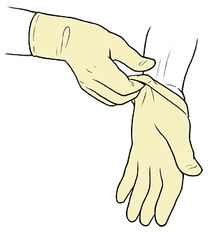 Gloved hand pulling sterile glove up to wrist of opposite hand.