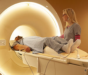 Technician preparing man for MRI scan.
